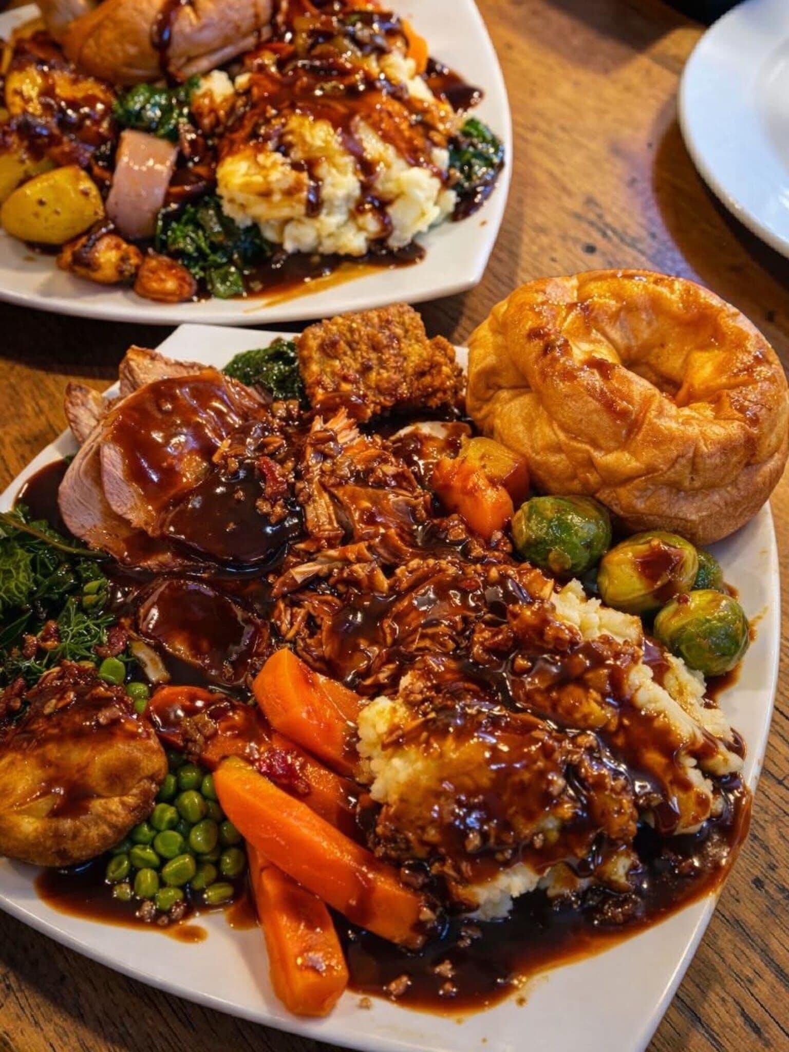 A loaded carvery plate of roast meats, a giant Yorkshire pudding, vegetables and gravy at The Lakeside Inn