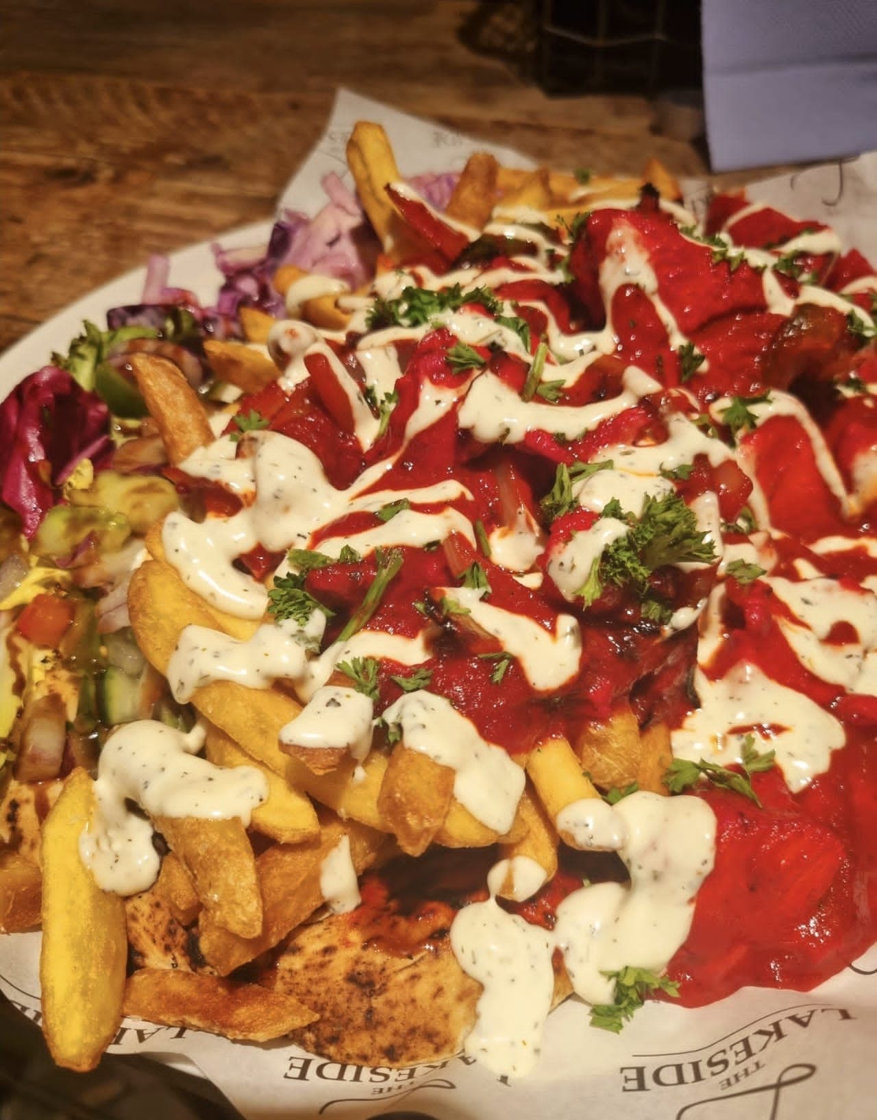 Loaded kebab fries with chilli sauce, garlic mayo and salad on Lakeside paper at The Lakeside Inn