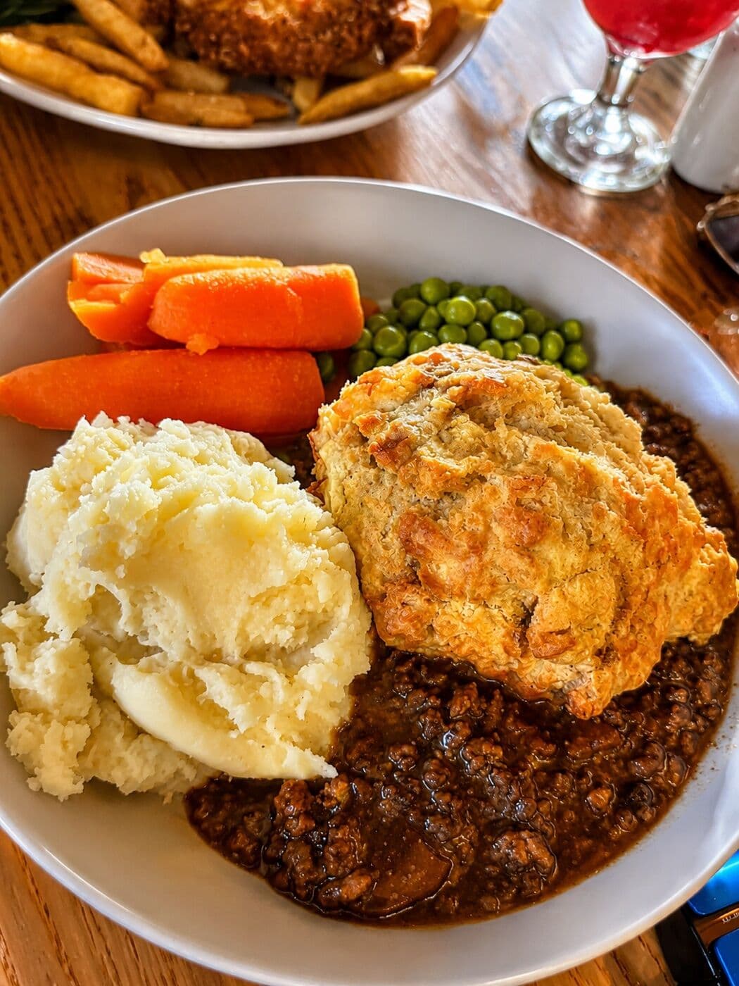 Mince and dumpling with creamy mash, carrots and peas at The Lakeside Inn