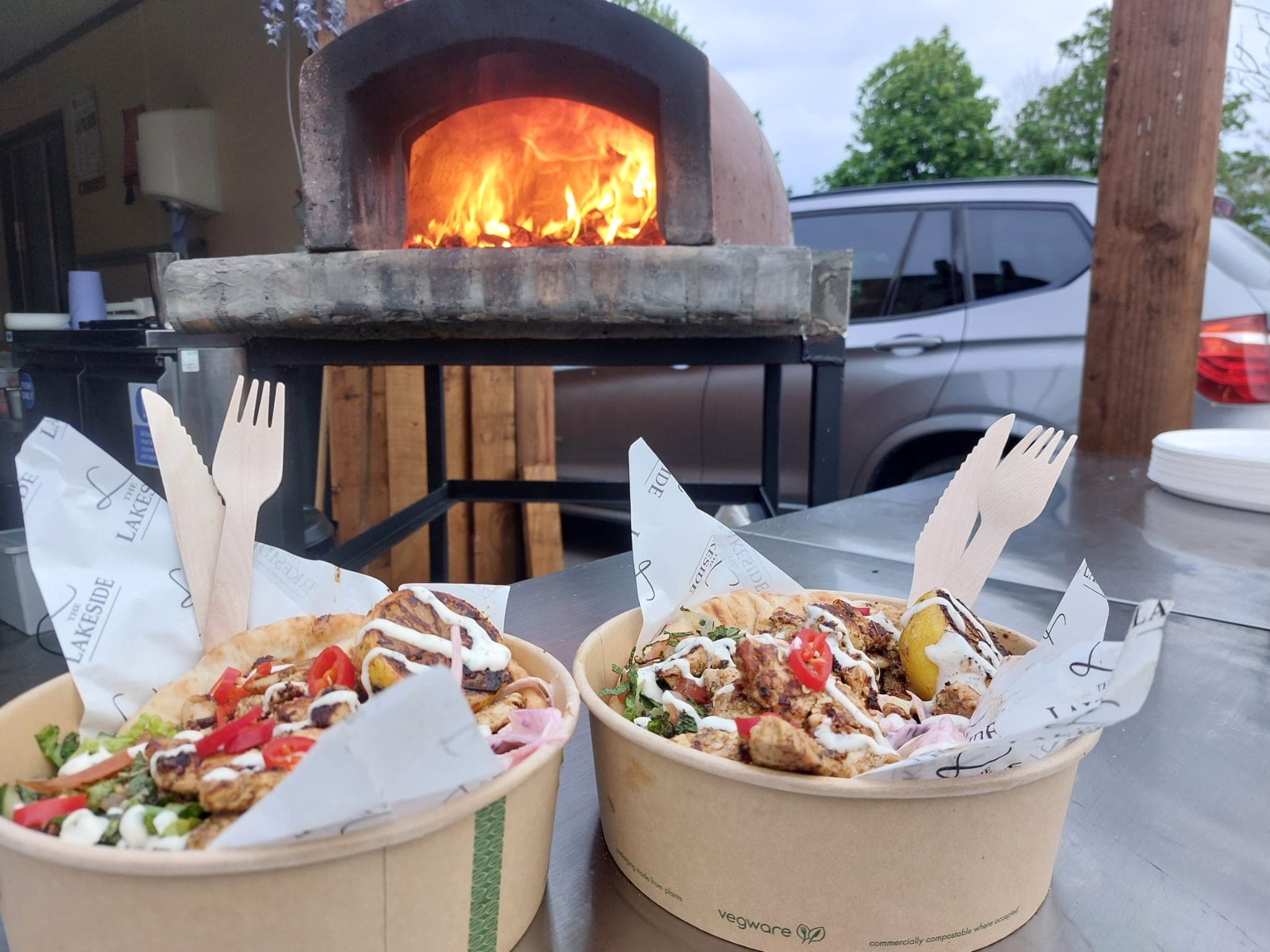 Freshly grilled street food boxes beside the wood-fired oven at The Lakeside